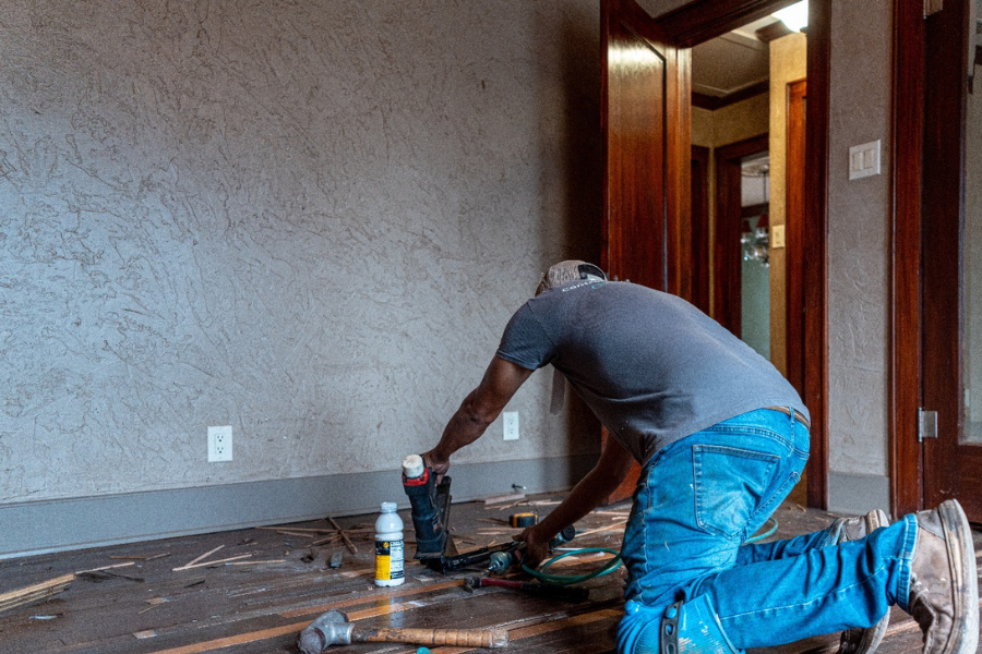 Emilio Flooring flooring installer fixing subfloors in customer's home.